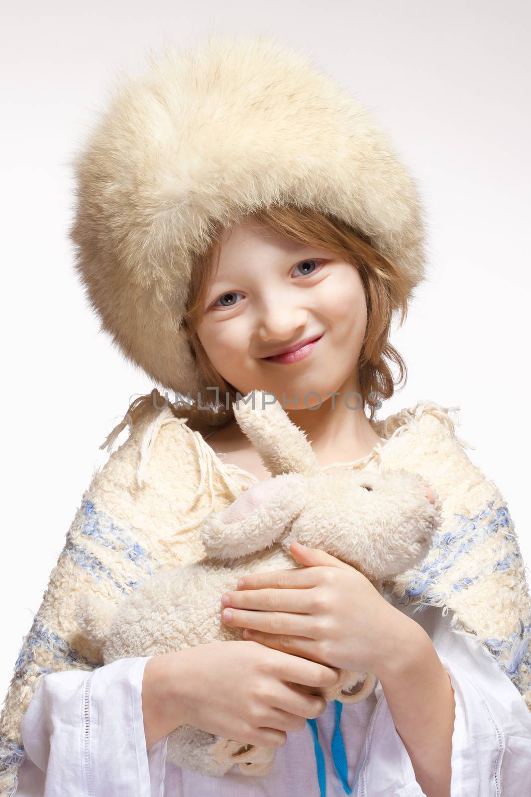 Portrait of a Boy with Fluffy Hat and Stuffed Animal by courtyardpix
