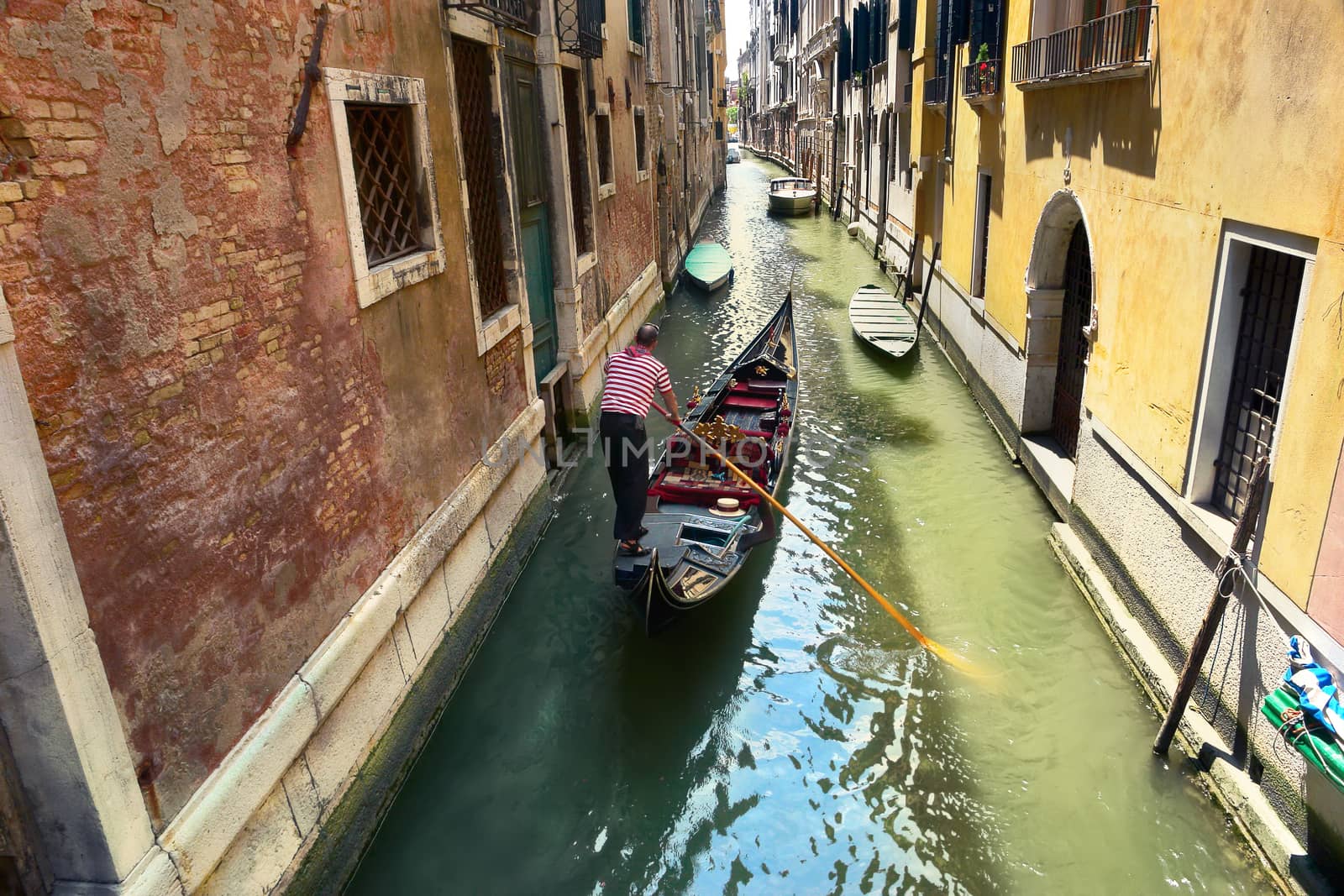 gondolier on the way to the grand canal, venice, italy