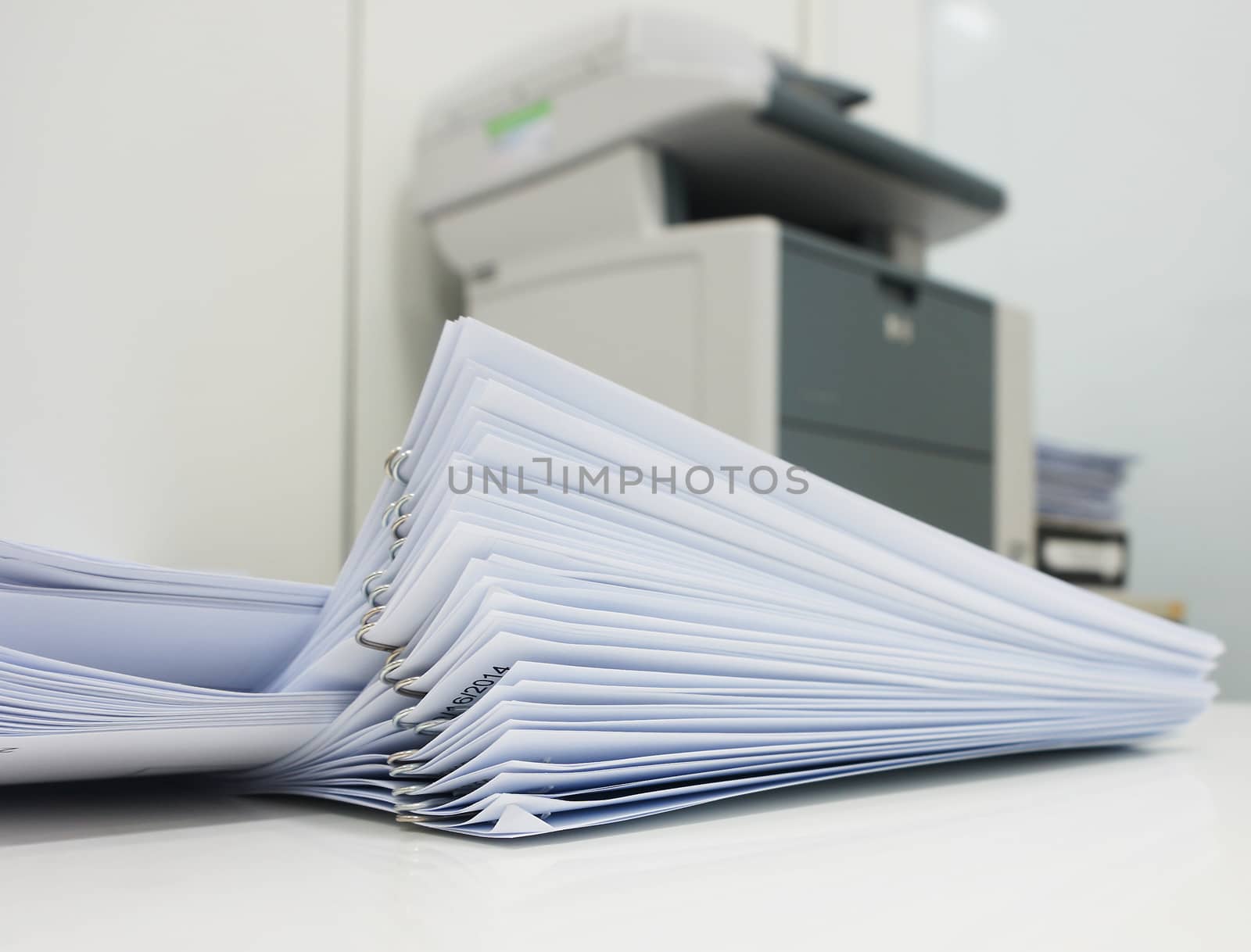 The document has been printed, be set and arranged as pile in front of the copier at office.                               