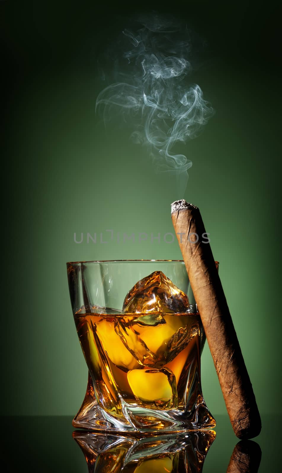 Whiskey and cigar on a green background