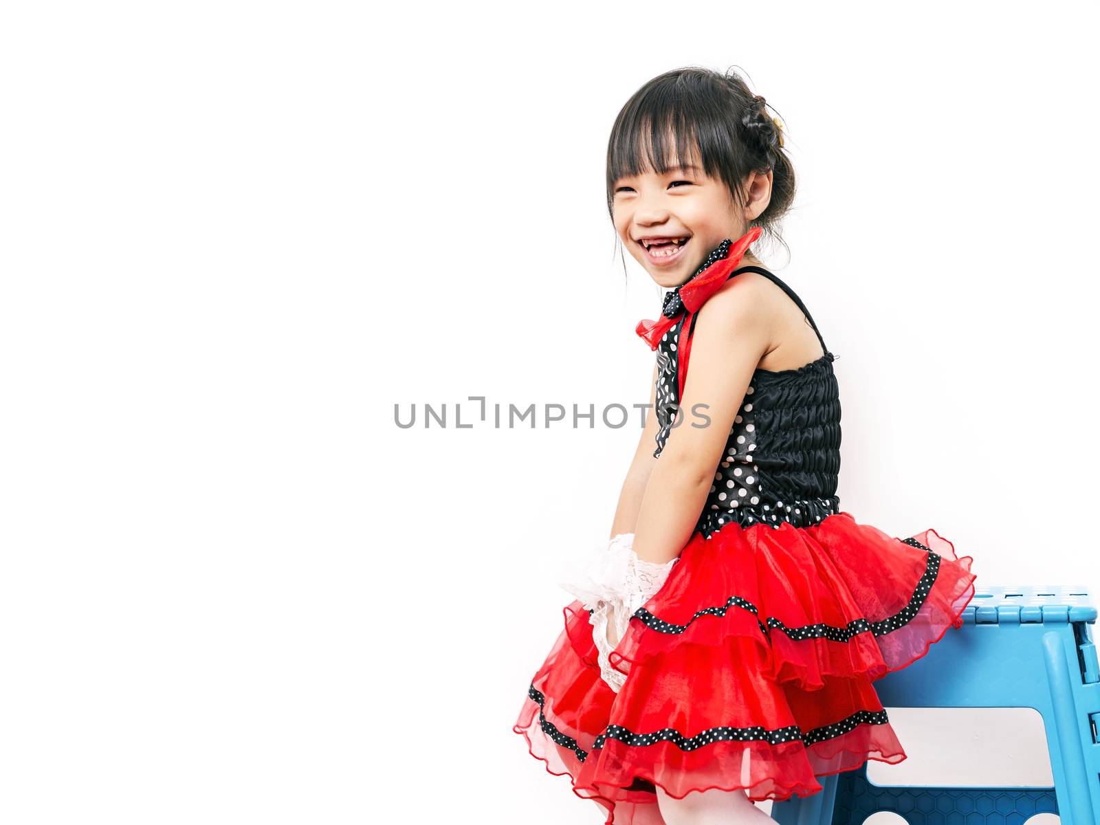 child girl in red suit on white background