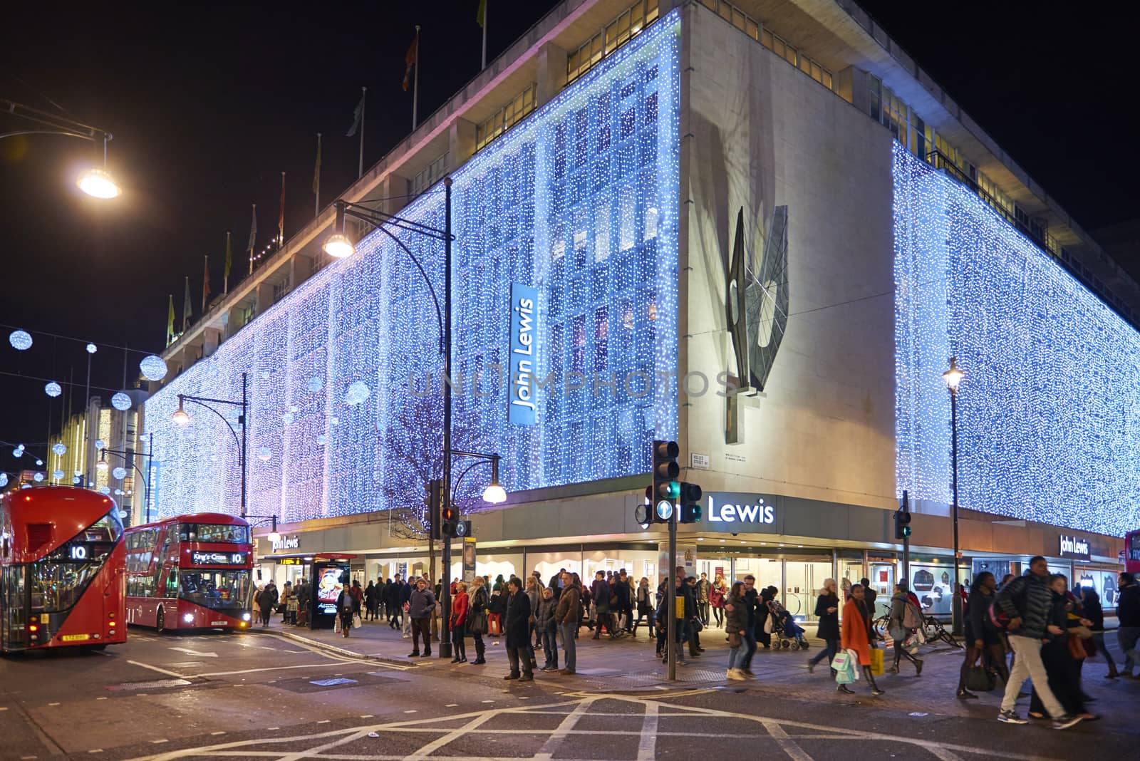 LONDON, UK - DECEMBER 20: Nighttime shot of John Lewis department store exterior in busy Oxford  street with wall of lights as part of its Christmas decorations. December 20, 2014 in London.