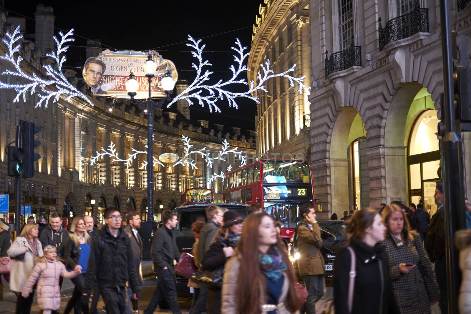 LONDON, UK - DECEMBER 19: Very busy Regent street at night, with Chrismas decoration and red double decker buses in the background. December 19, 2014 in London.