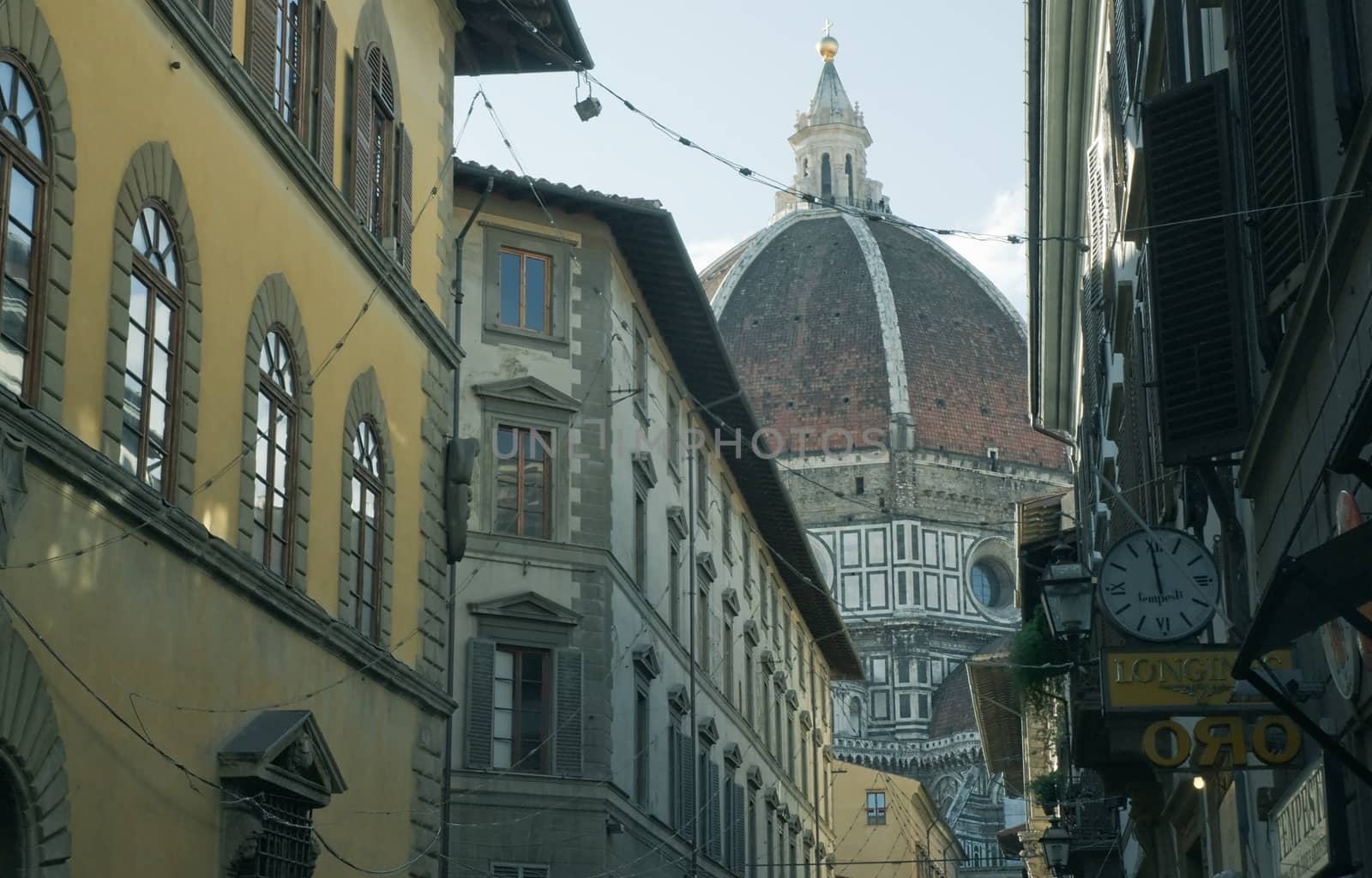 Small street in Florence with Duomo dome in the background