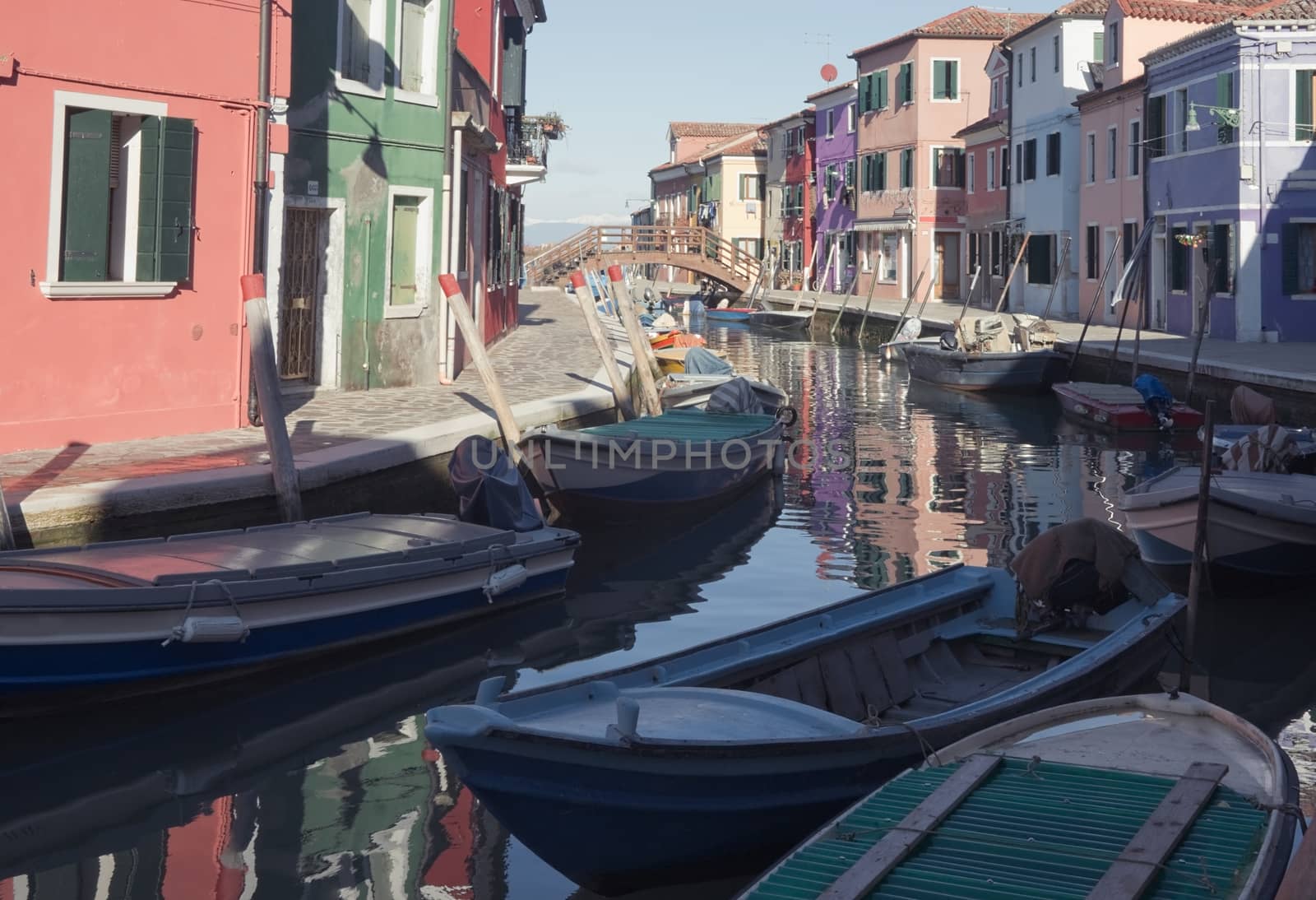 Colorful houses and boats on the island of Burano near Venice