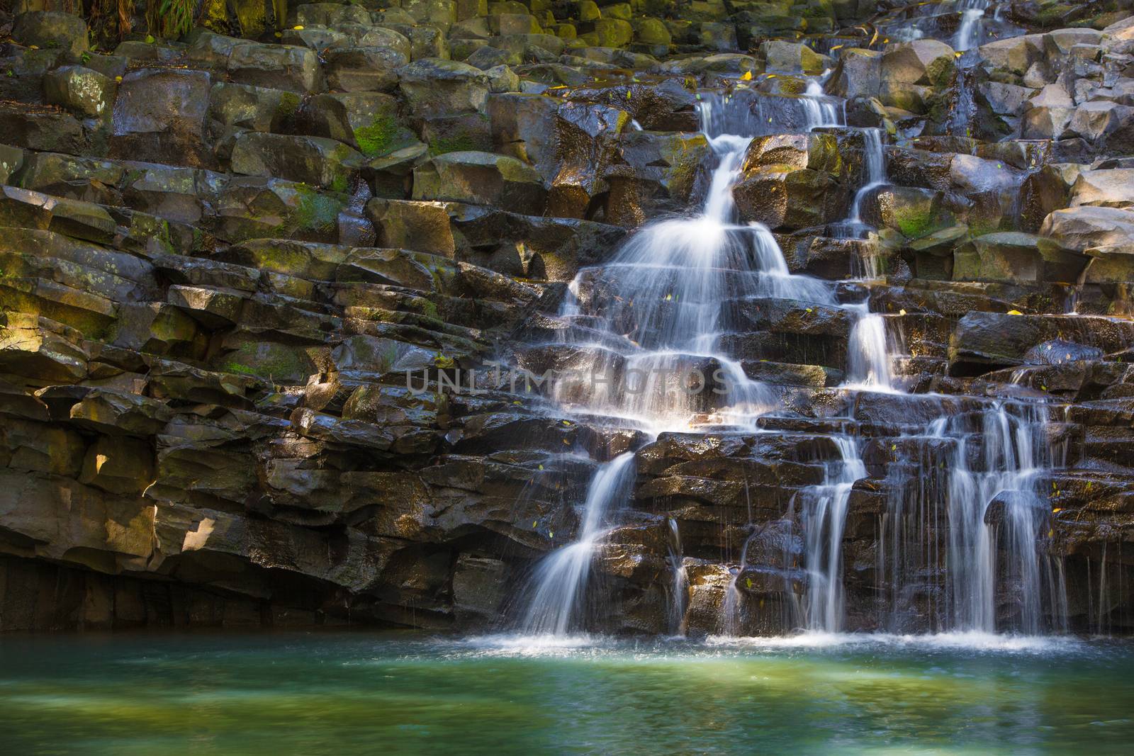 Water falling over rocks into pond in Maui Hawaii