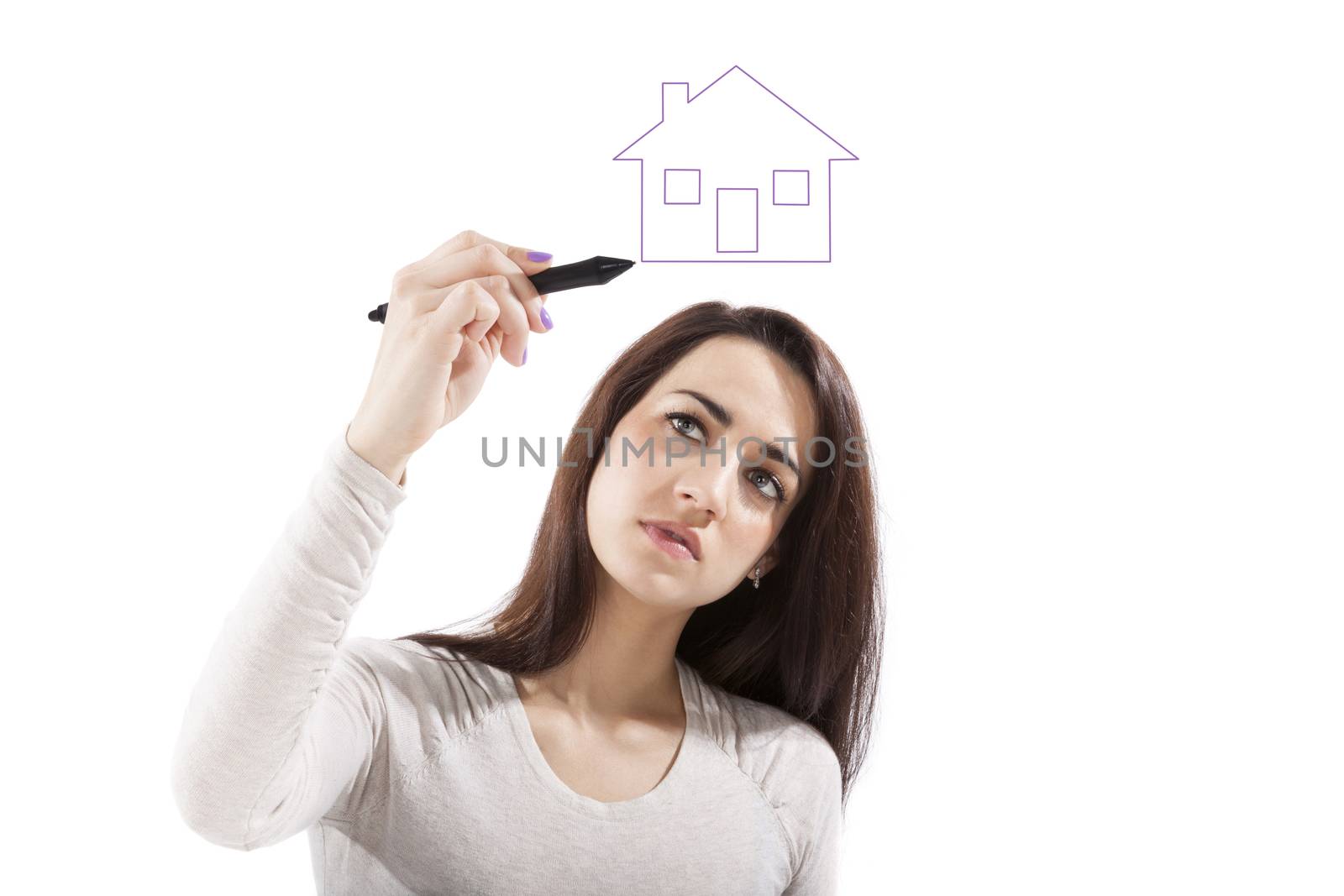 Young beautiful girl drawing house isolated on white background. Home, sweet home. Thinking about the future.
