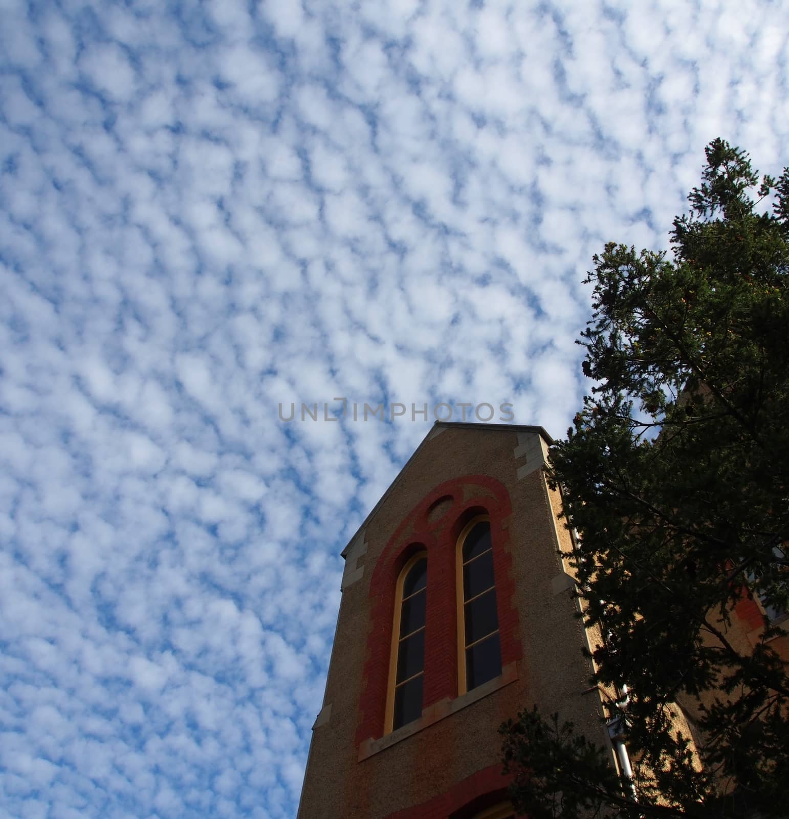 Old Building with blue sky and interesting patterns in the clouds