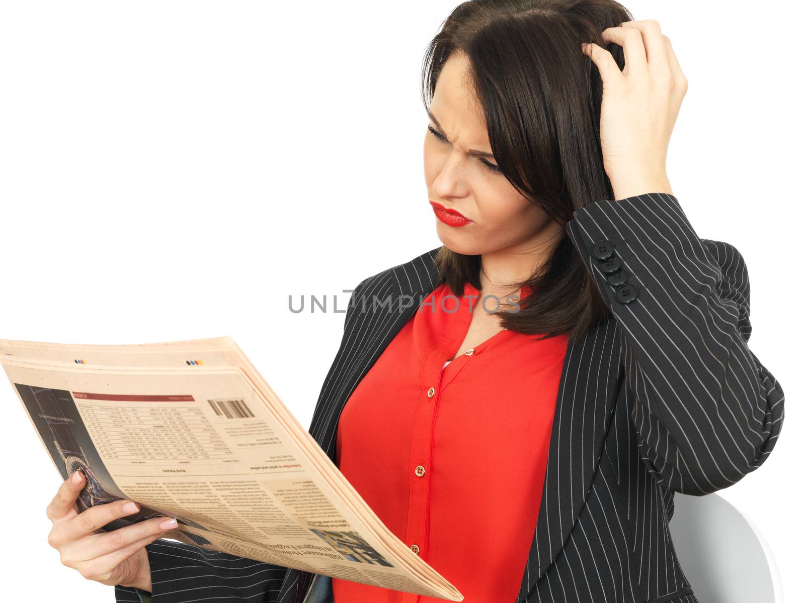 Young Business Woman Reading a Newspaper by Whiteboxmedia