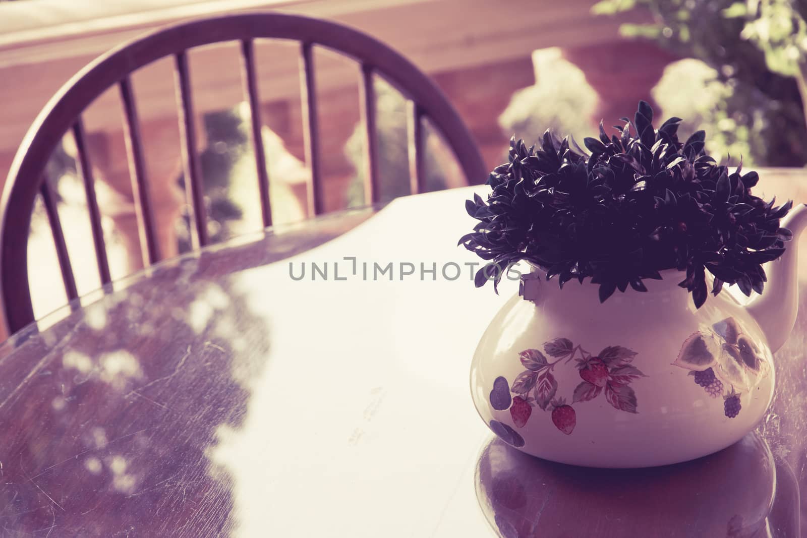 Image of vintage chair and table with flower