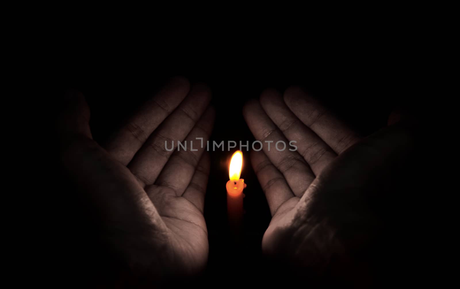 Candle light in hand, Hope concept by pixbox77