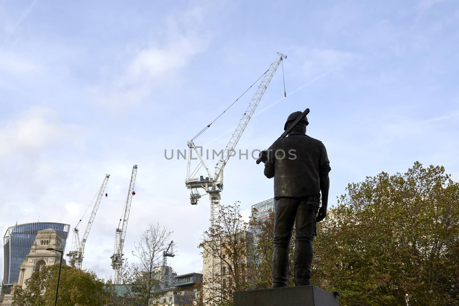 LONDON, UK - NOVEMBER 08: The Building Worker statue, near the Tower of London. NOVEMBER 08, 2014 in London. The statue commemorates construction workers who have lost their lives at work. 