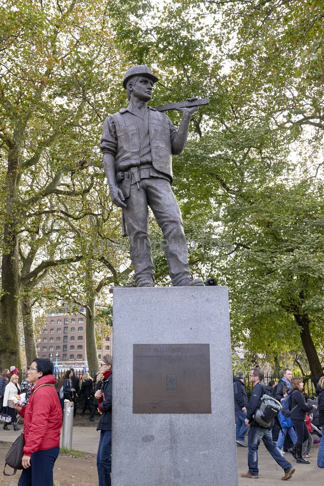 LONDON, UK - NOVEMBER 08: The Building Worker statue, near the Tower of London. NOVEMBER 08, 2014 in London. The statue commemorates construction workers who have lost their lives at work. 