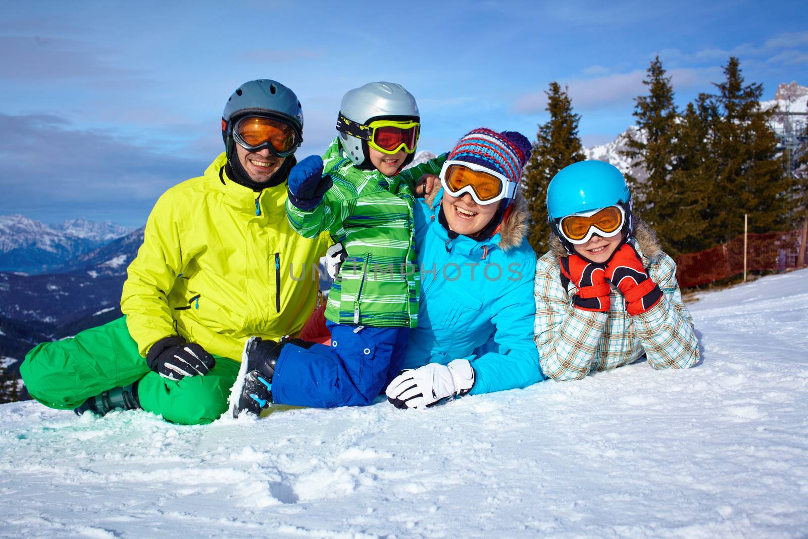 Skiers, sun and fun - Family enjoying winter vacations.