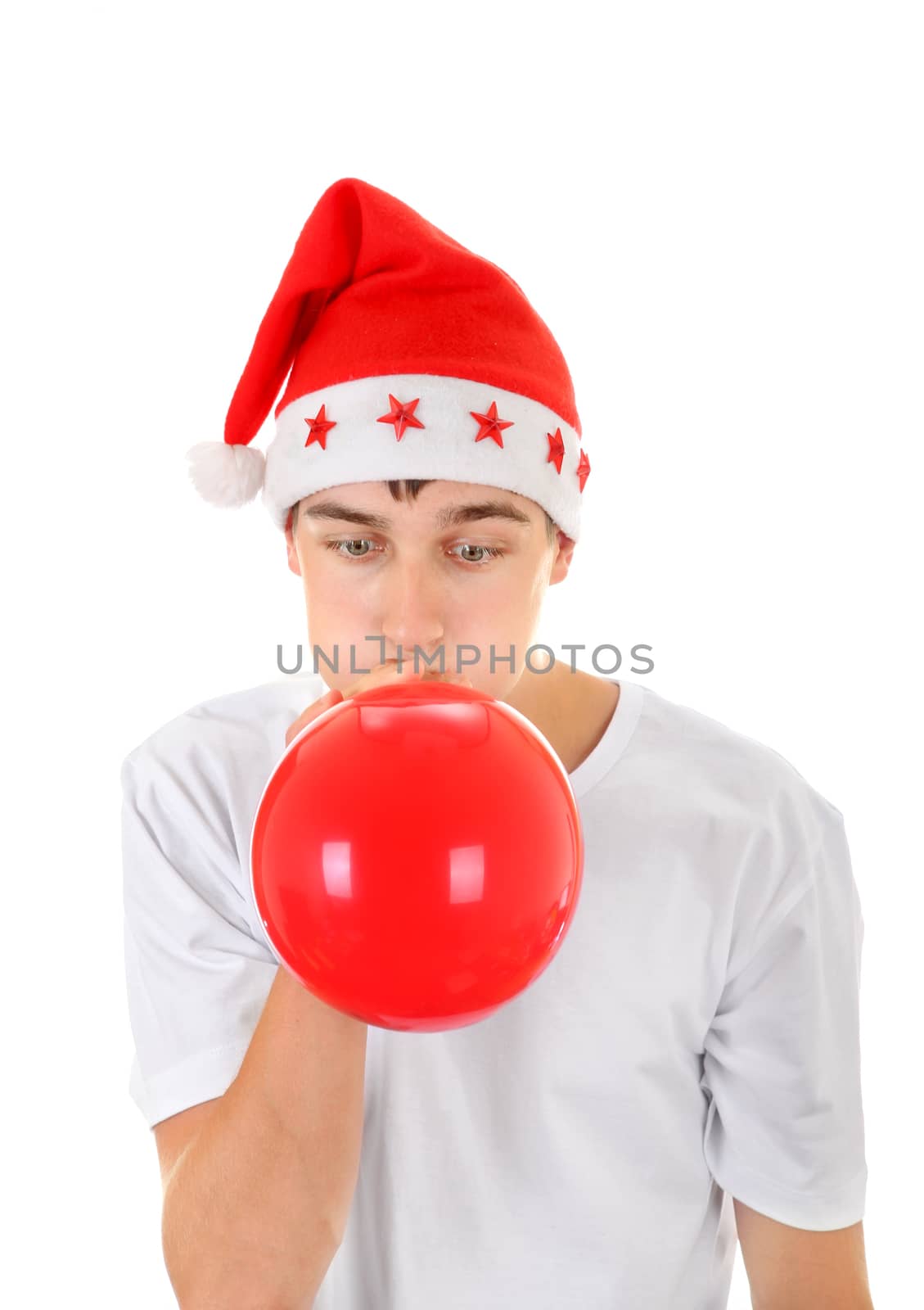 Teenager in Santa's Hat inflate Red Balloon Isolated On The White Background