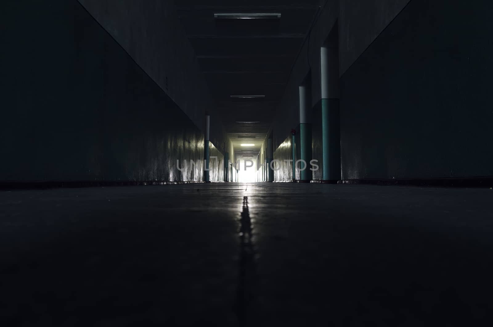 dark corridor with light in horizon by mycola