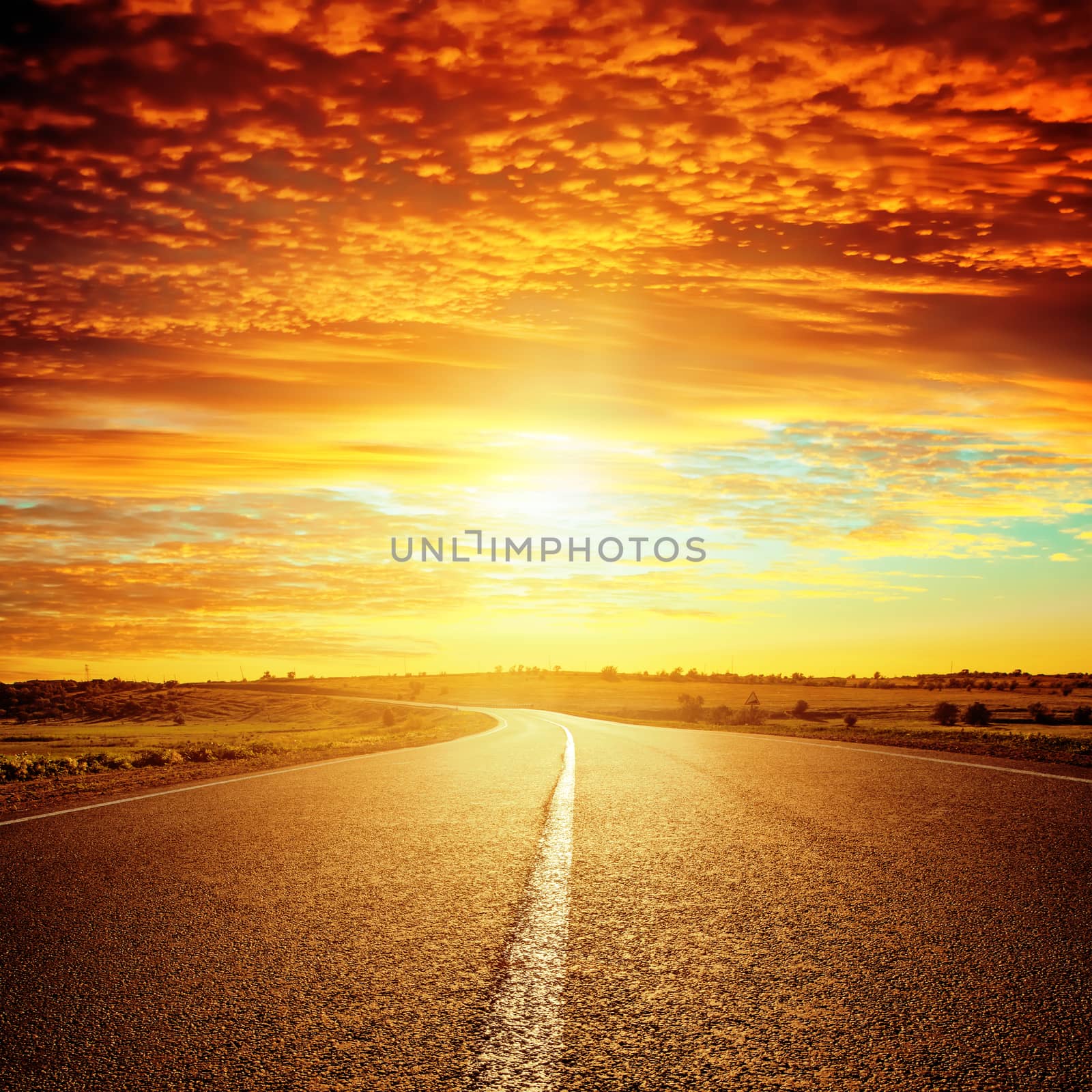 good red sunset and asphalt road to horizon by mycola