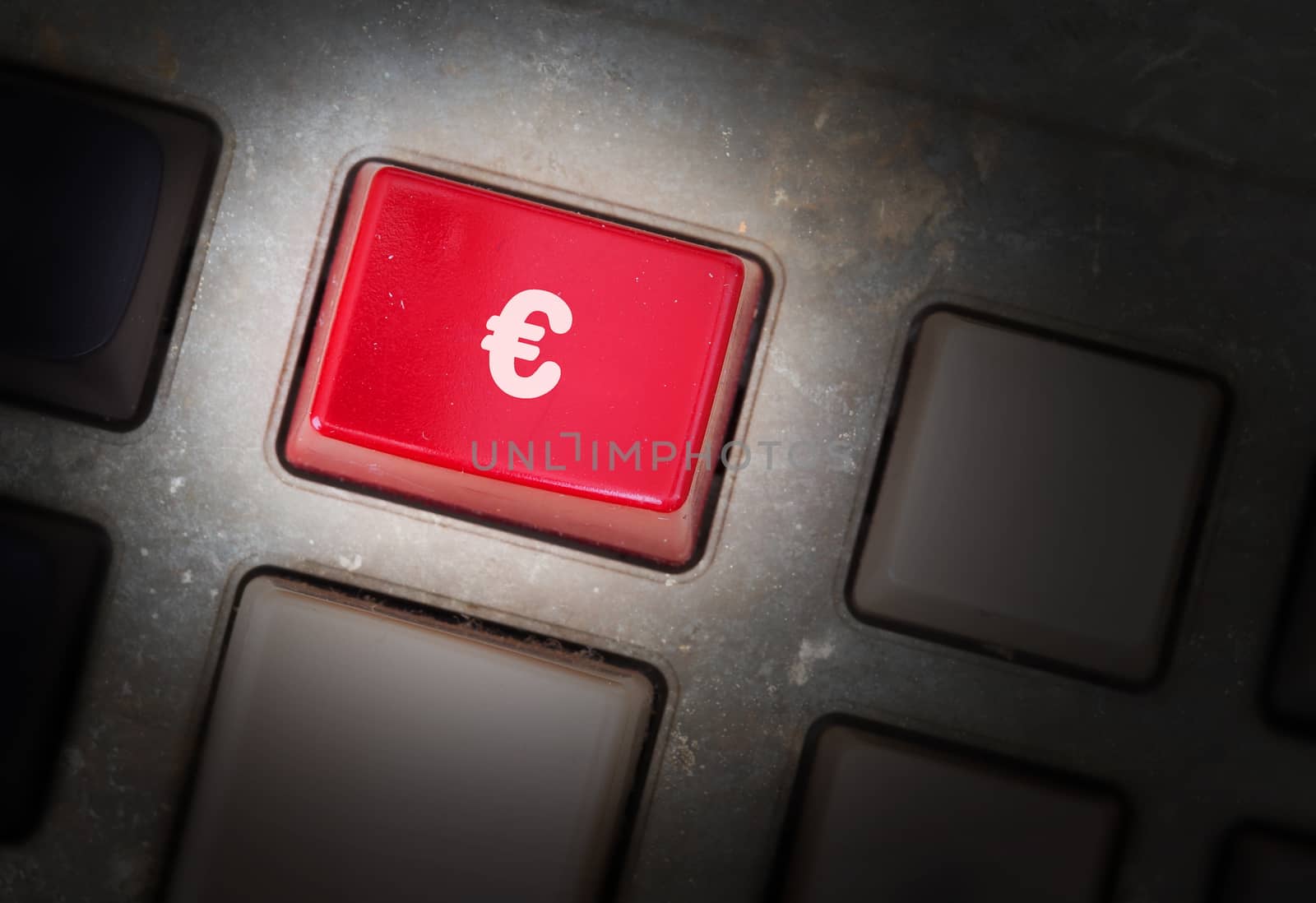 Red button on a dirty old panel, selective focus - euro sign