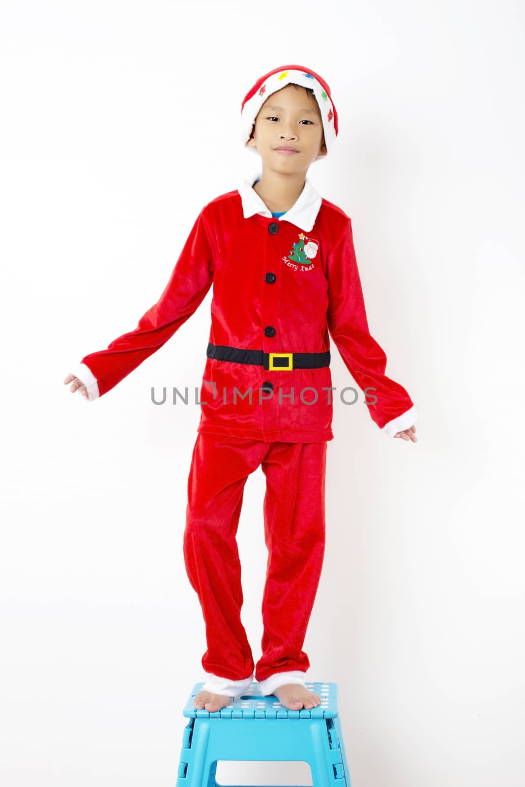 Asian little boy in red santa hat on white background by Yuri2012