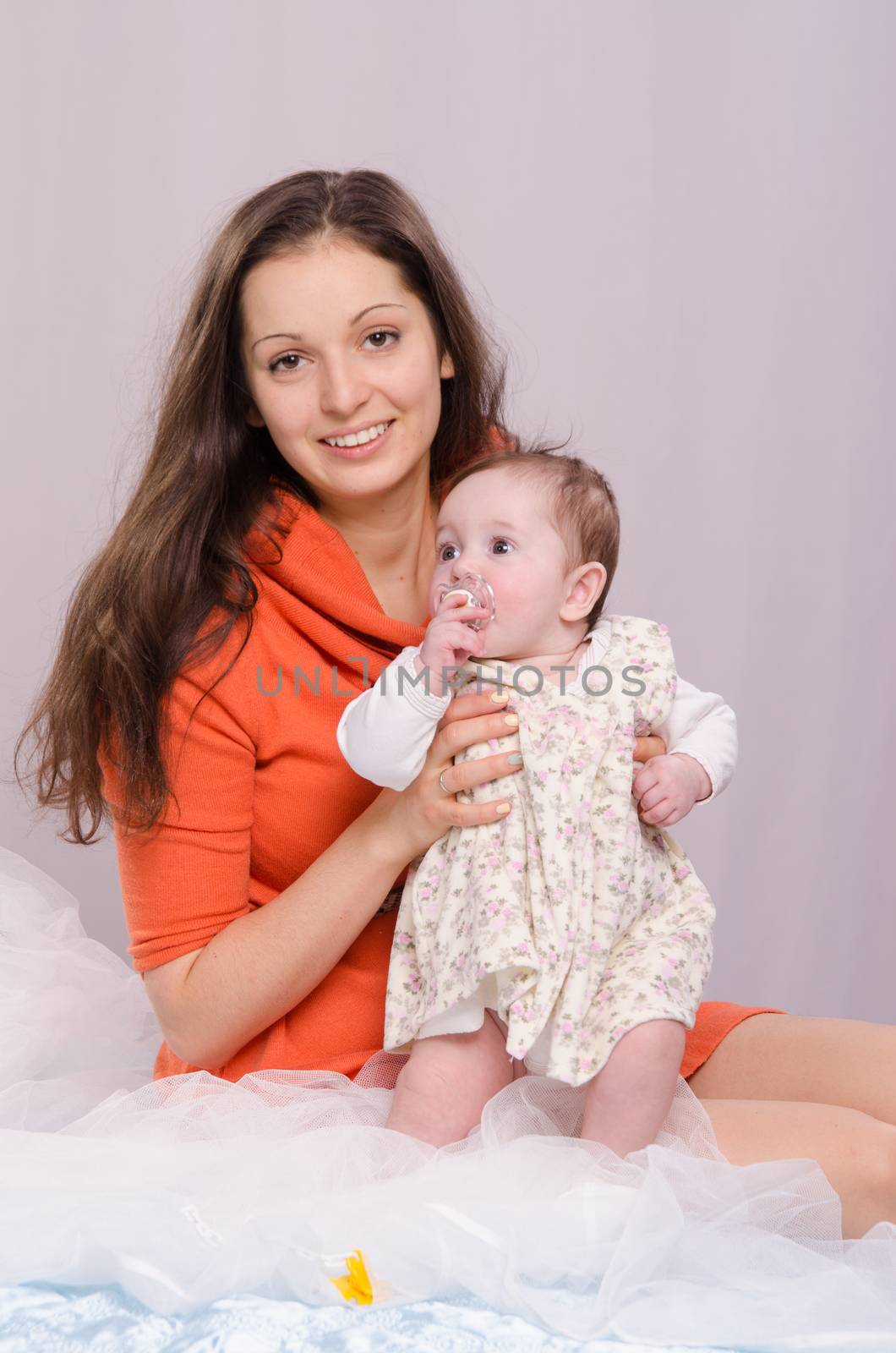 Mom and daughter on the bed six-month by Madhourse