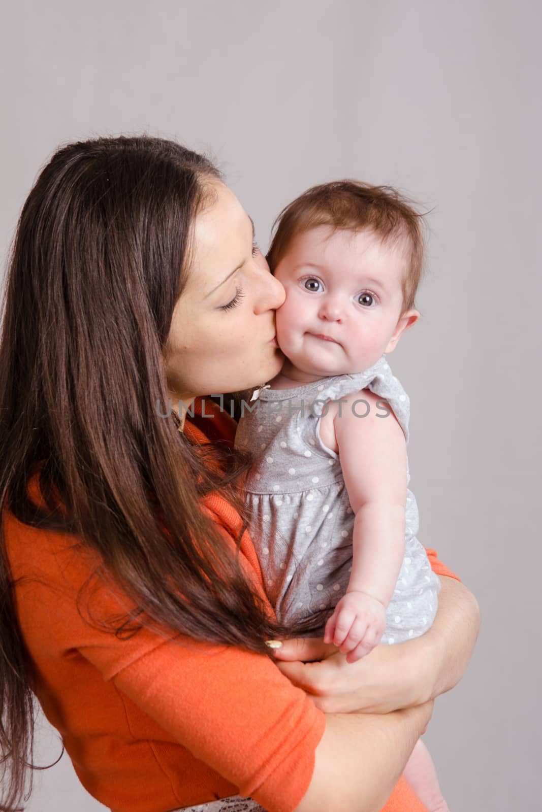 Portrait of mother and baby at the hands of six mothers