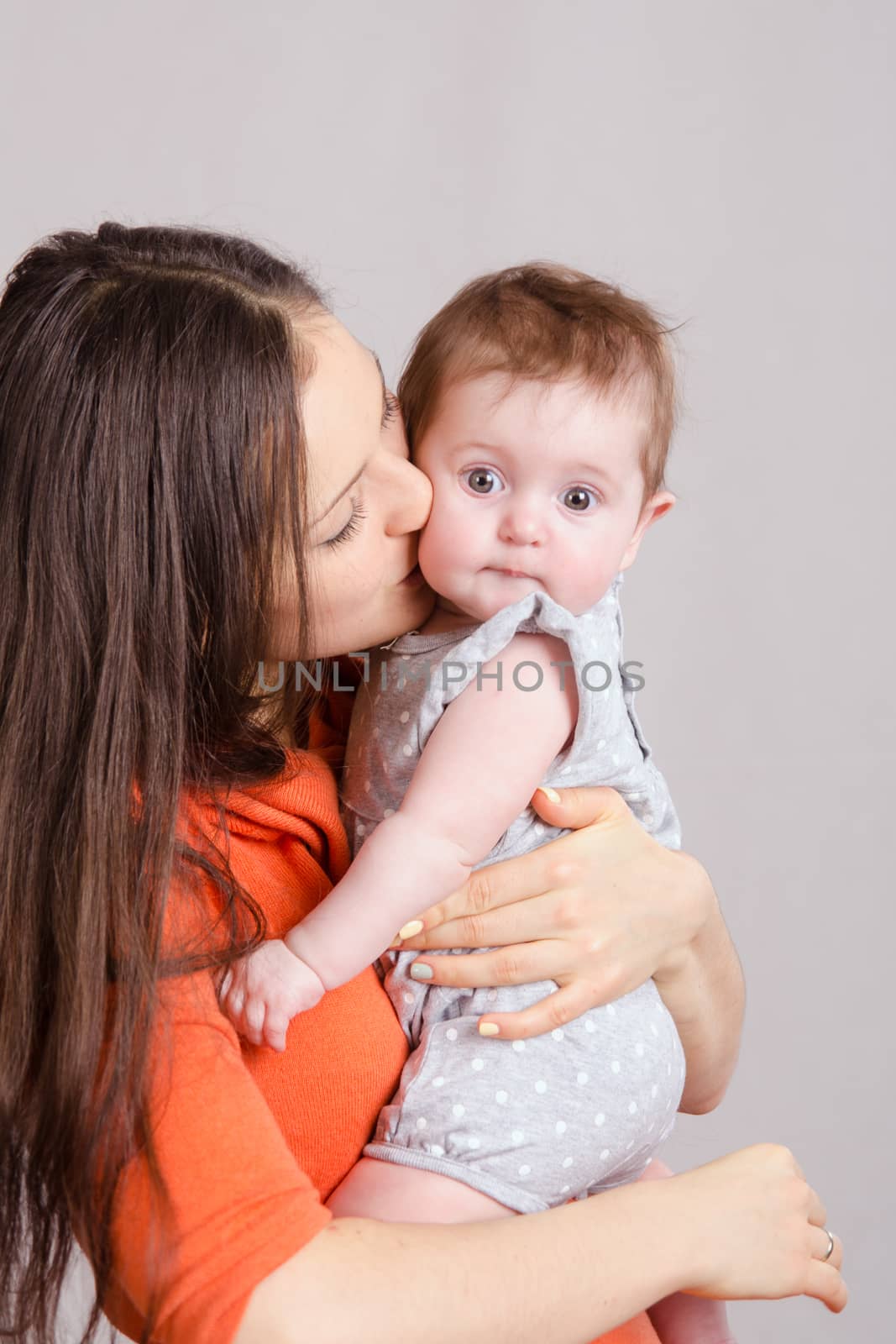 Portrait of mother and baby at the hands of six mothers