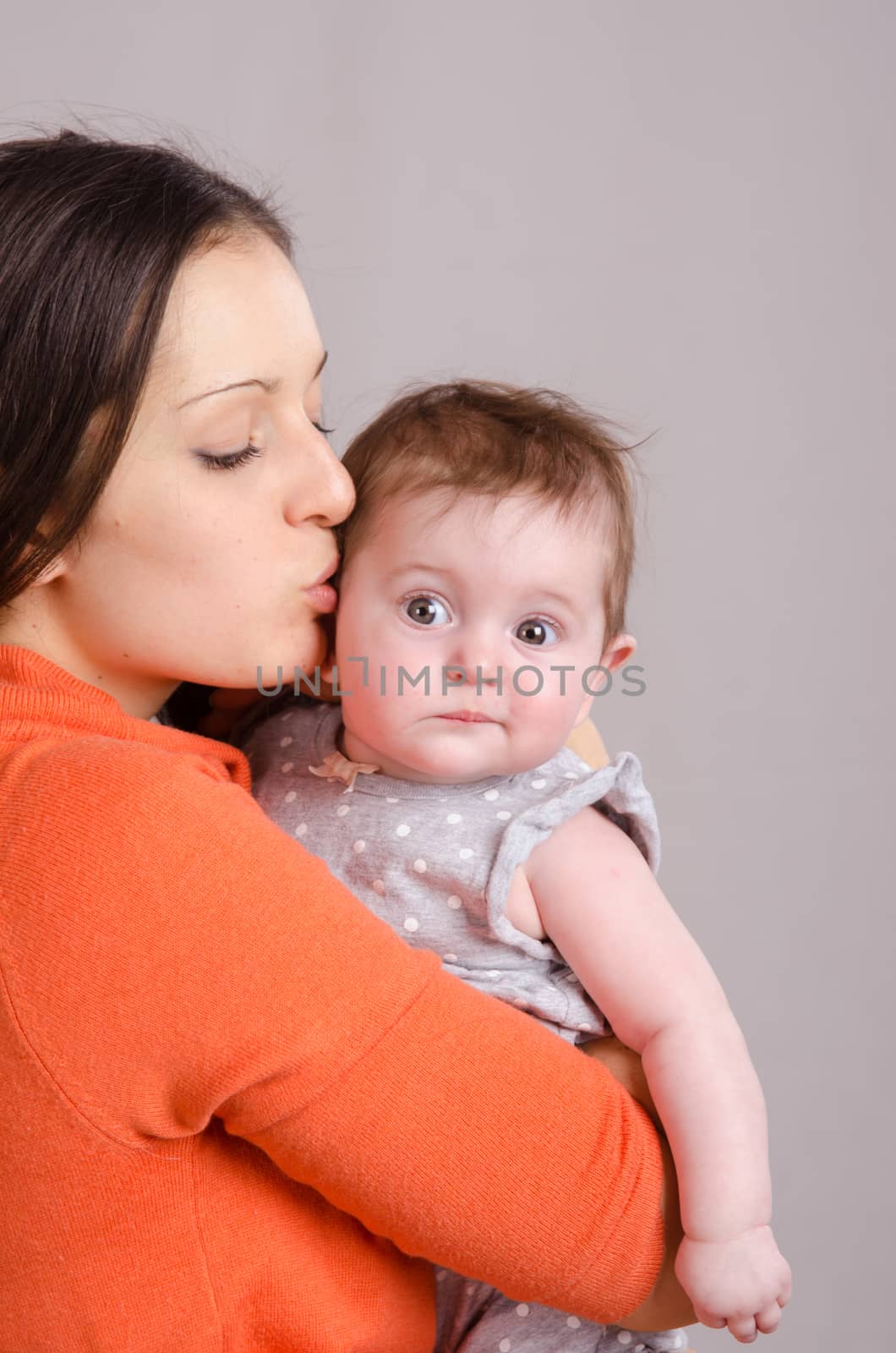 Portrait of mother and baby at the hands of six mothers
