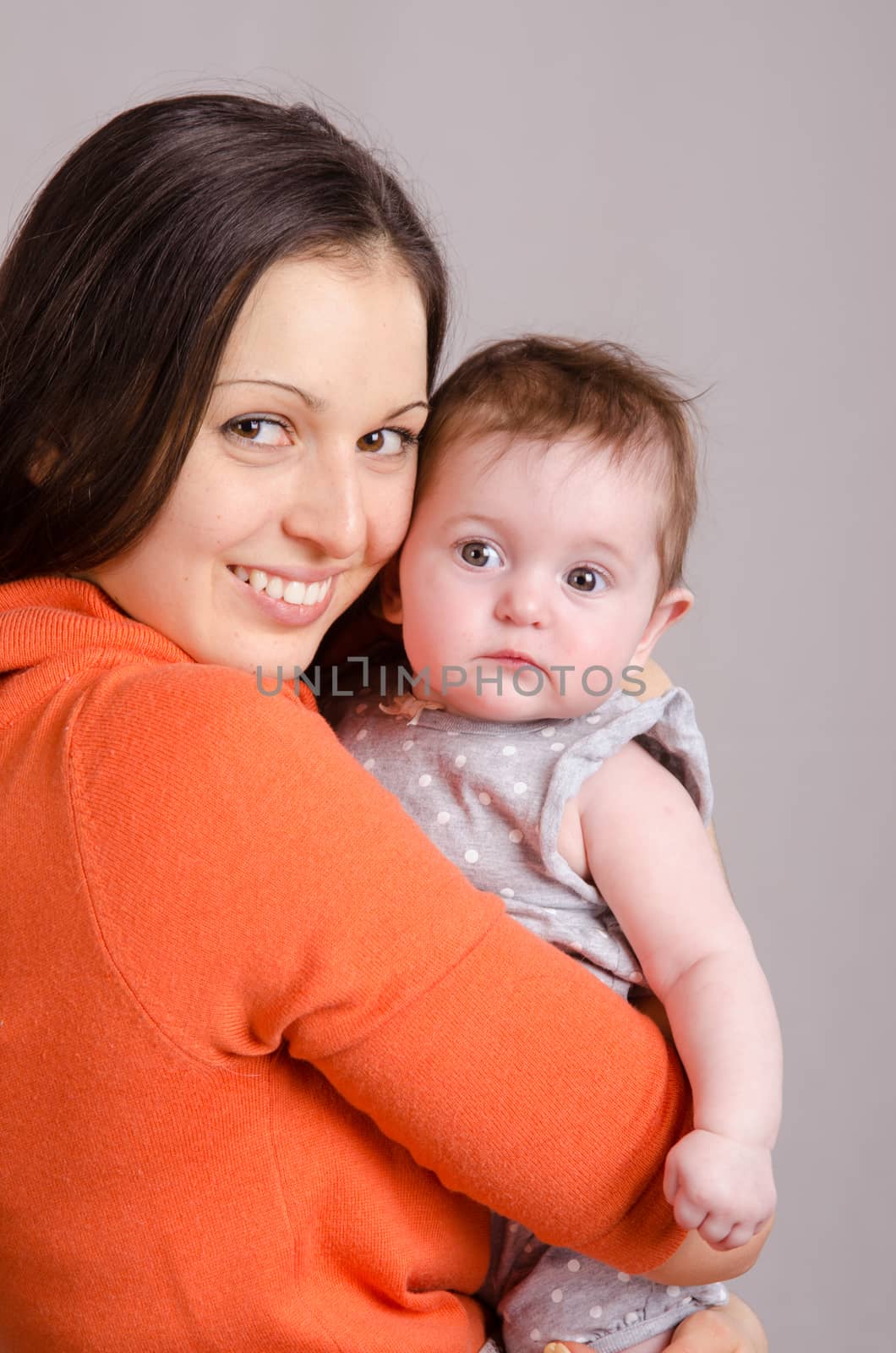 Portrait of mother and baby at the hands of six mothers
