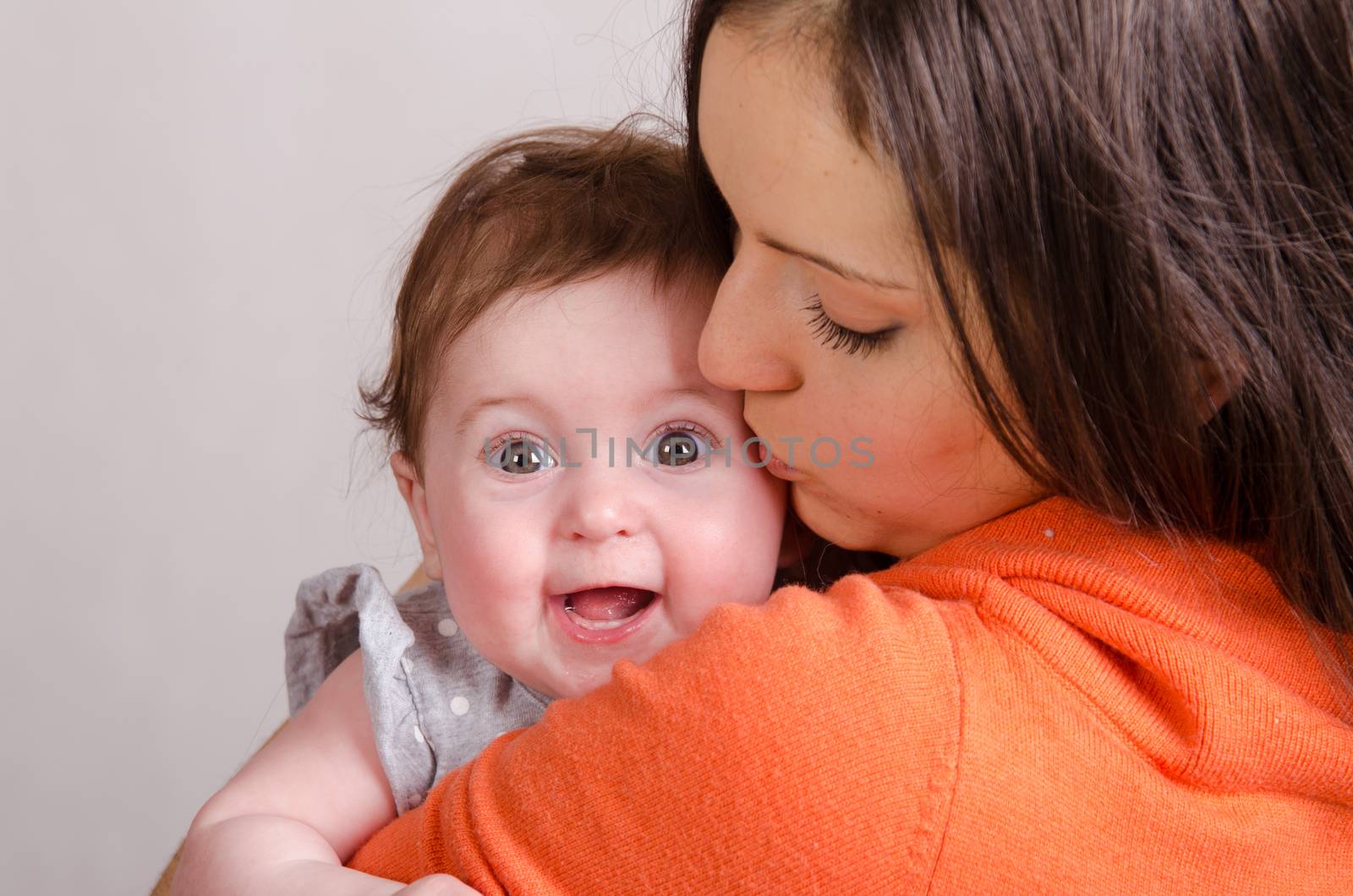 Portrait of mother and baby at the hands of six mothers
