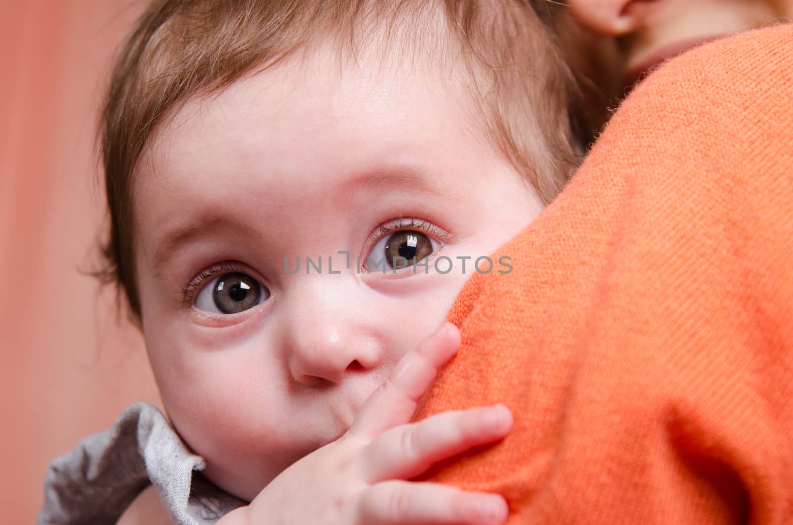 Portrait of mother and baby at the hands of six mothers