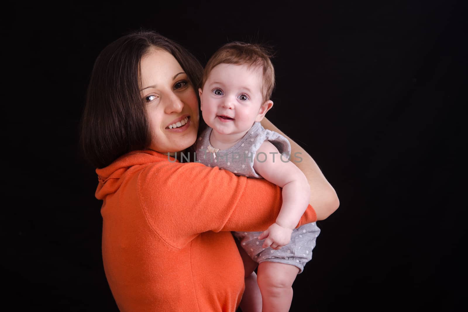 Portrait of mother and baby at the hands of six mothers