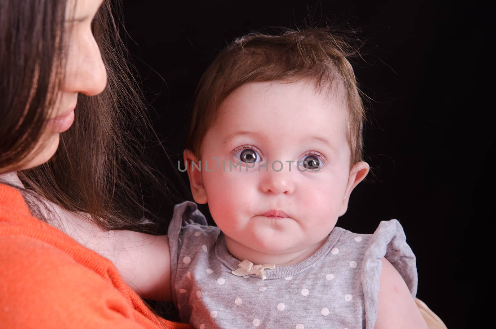 Portrait of six month baby on mother hands