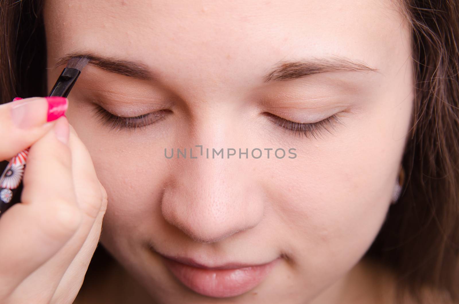 Makeup artist brush eyebrows brings young girl by Madhourse