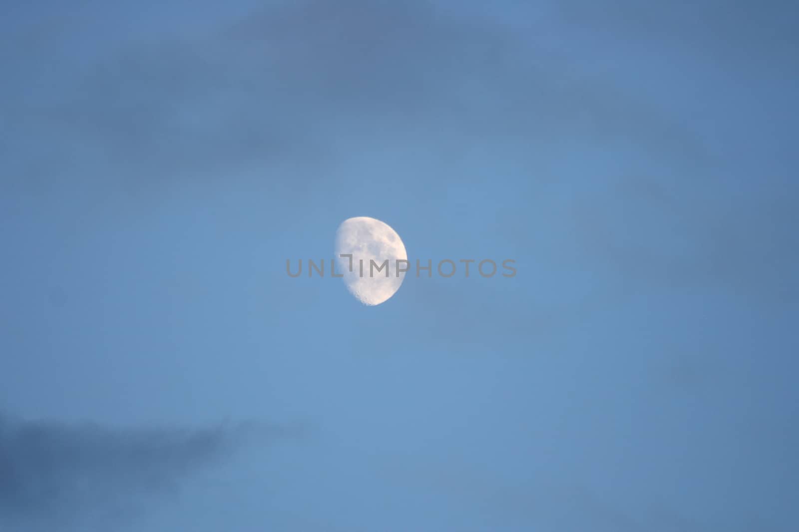 The moon with blue sky and dark clouds