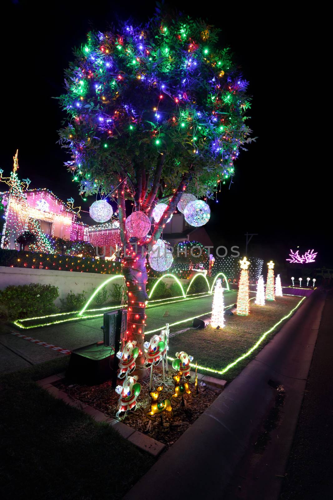 BEAUMONT HILLS, AUSTRALIA - DECEMBER 24, 2015;  Christmas lights decorations on house and manicured gardens create a joyful wonderland and  draw crowds of visitors each year with over 60000 lights with  music syncs  and donations are raised for charity