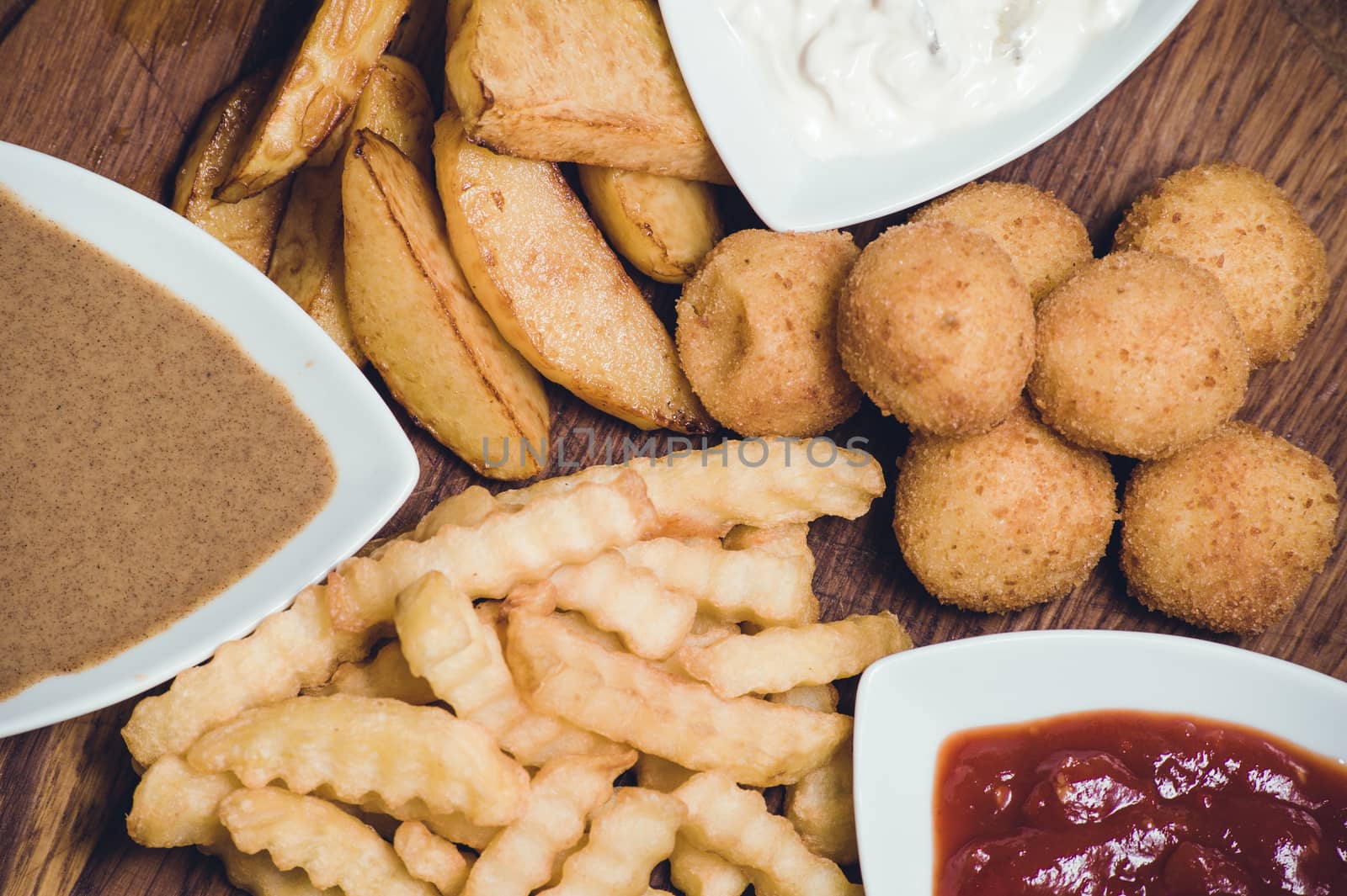 snack potato platter with dips on wooden board 