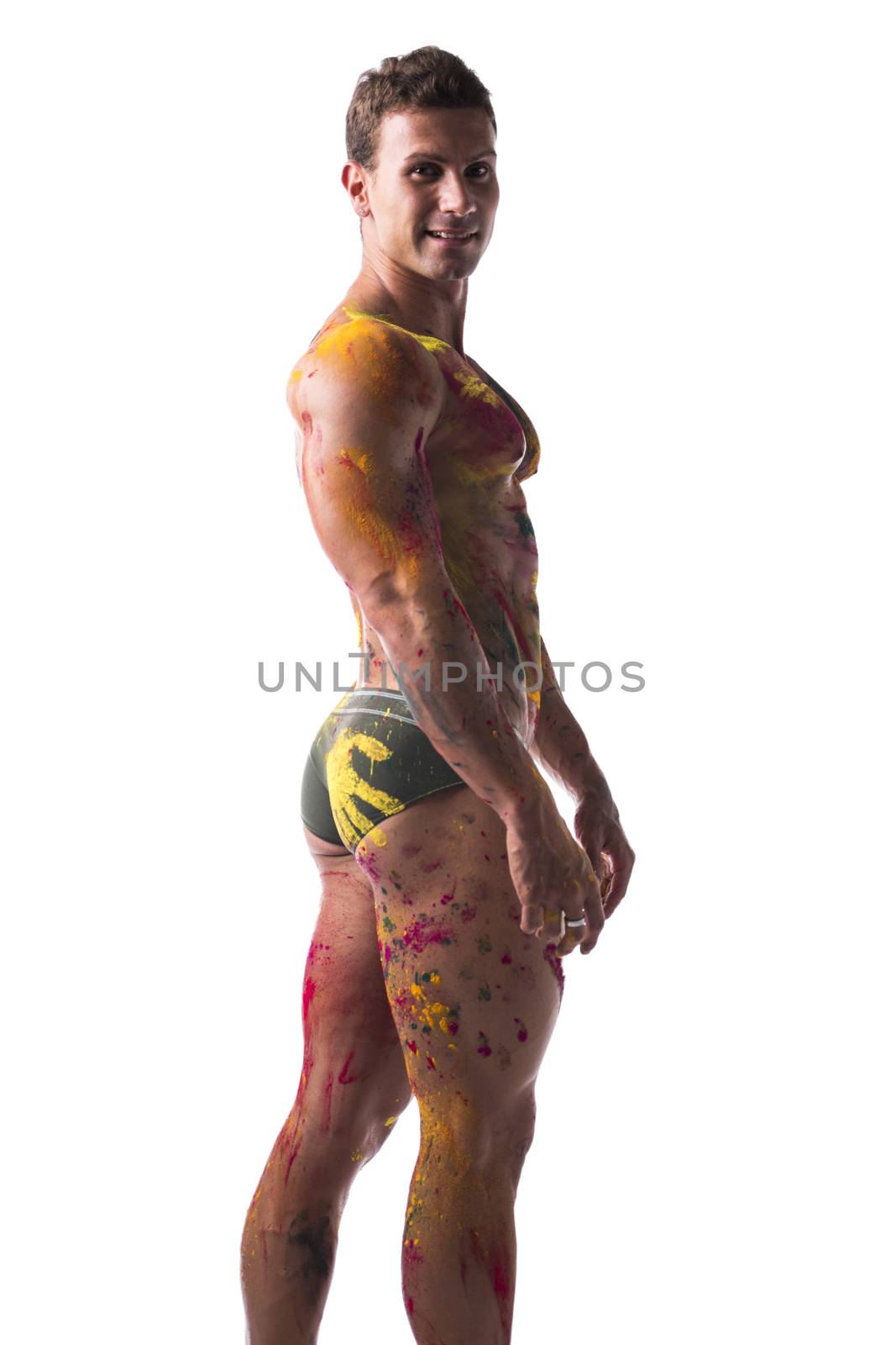 Muscular young man shirtless with skin painted with Holi colors by artofphoto