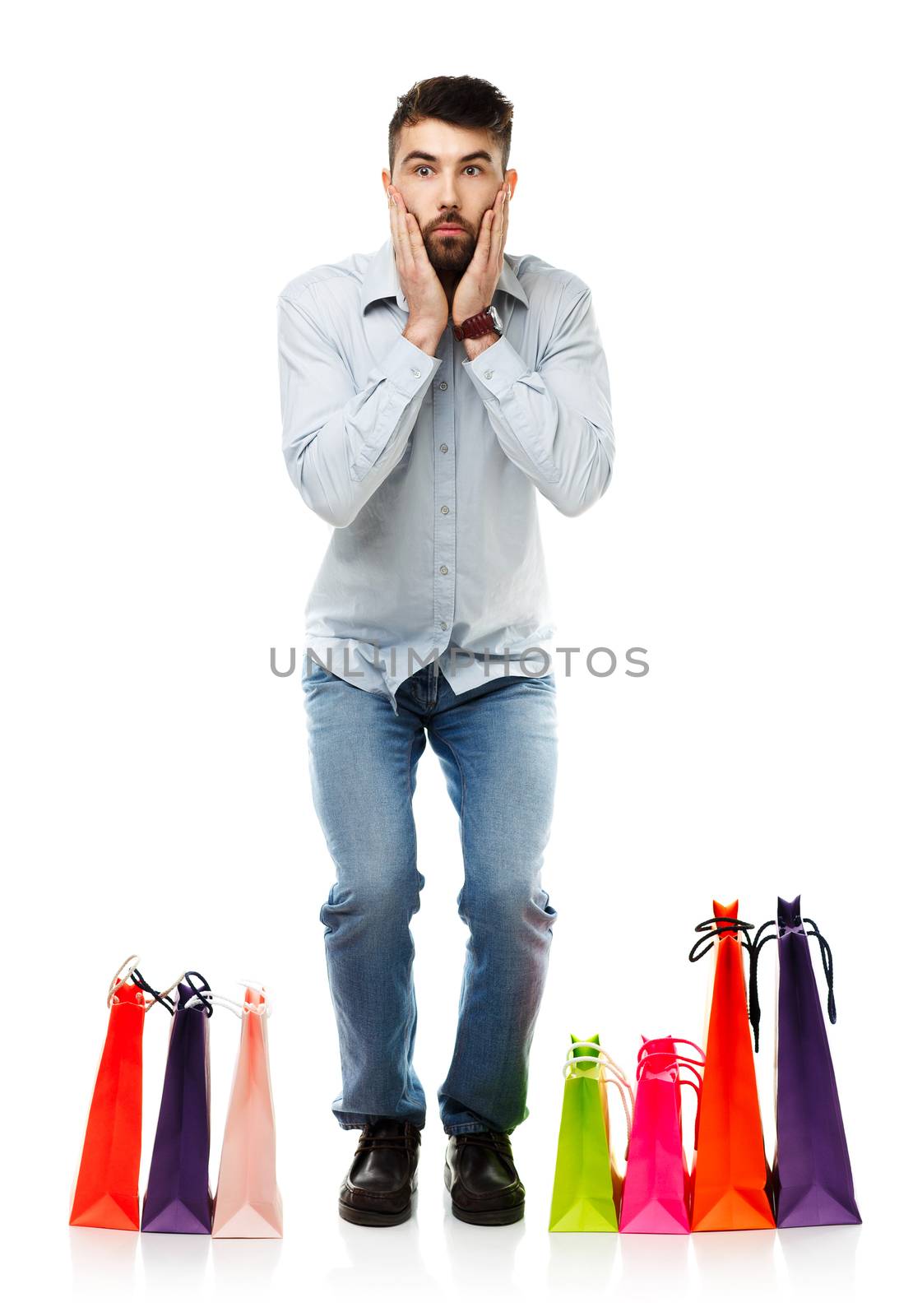 Handsome man with shopping bags is shocked. Christmas and holidays concept