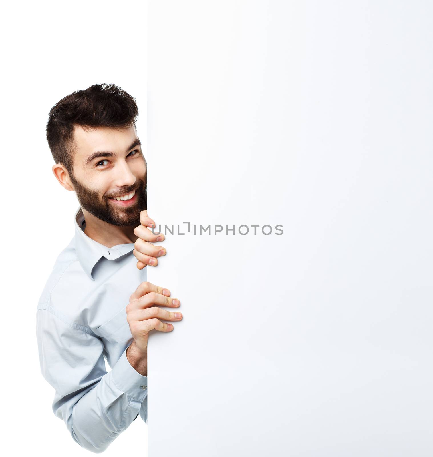 A young bearded man showing blank signboard, isolated over white background