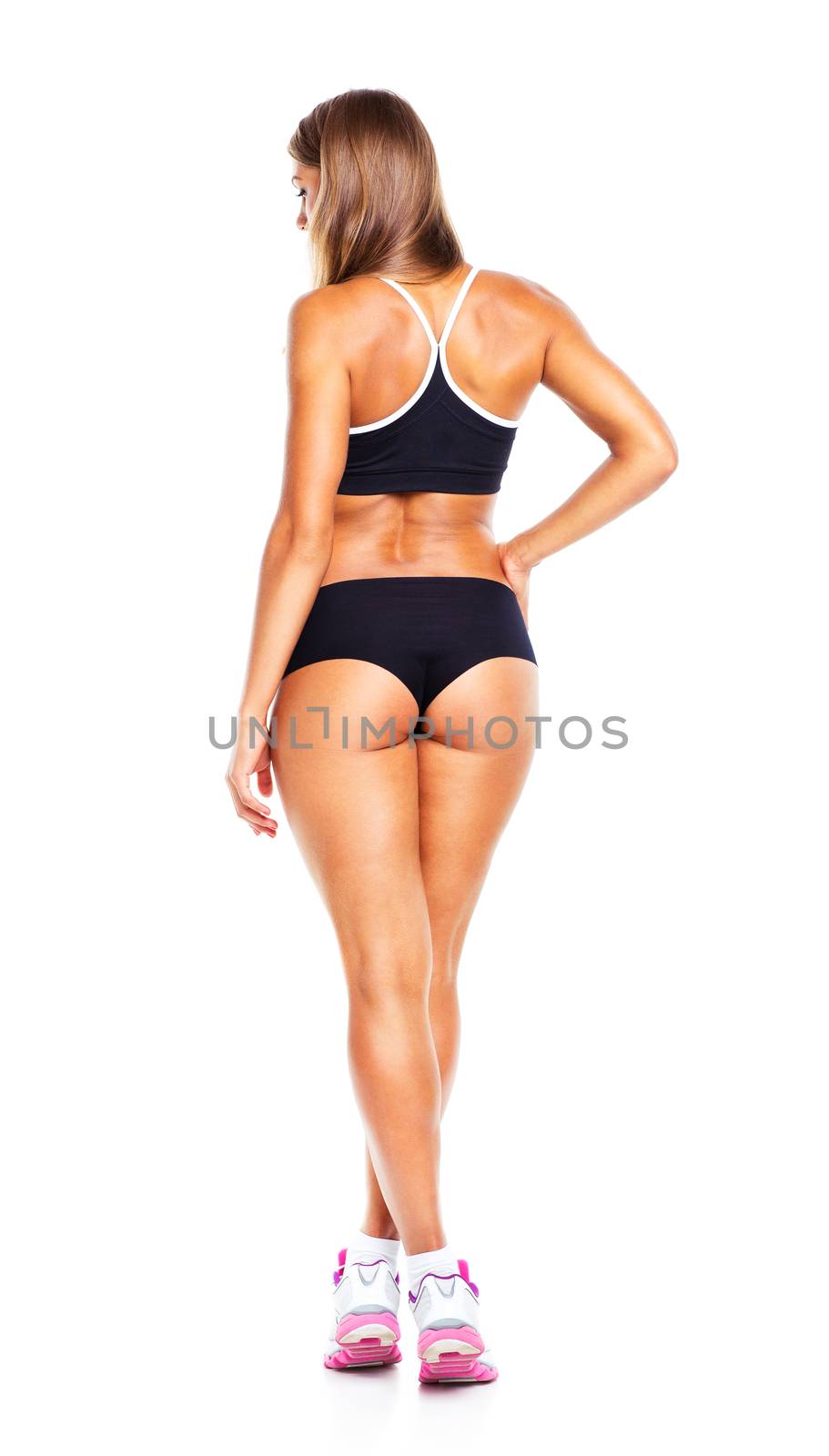 Young athletic girl on white background, view from the back