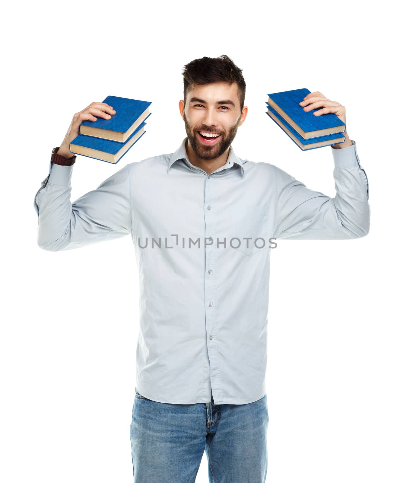 Young bearded smiling man with books in hands on white background