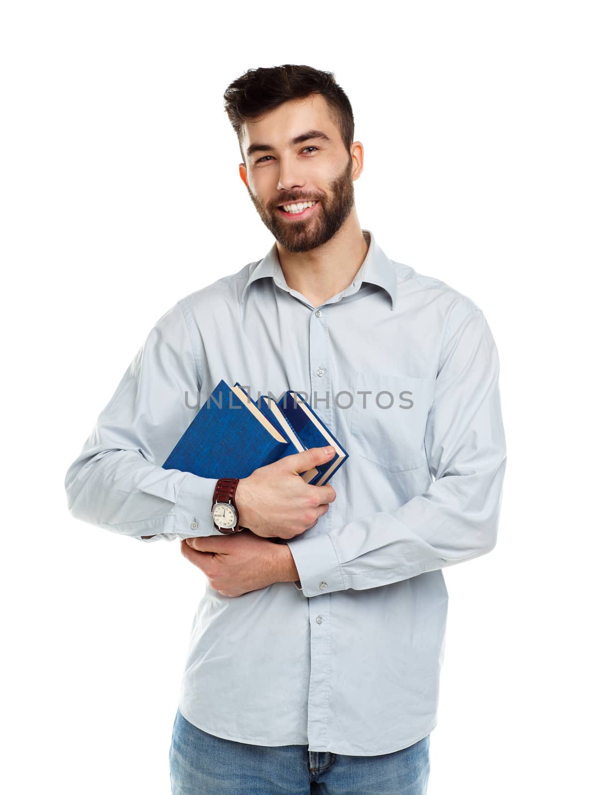 Young bearded smiling man with books in hands on white background