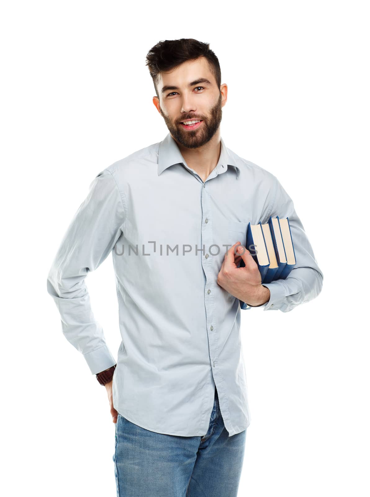 Young bearded smiling man with books in hands on white background