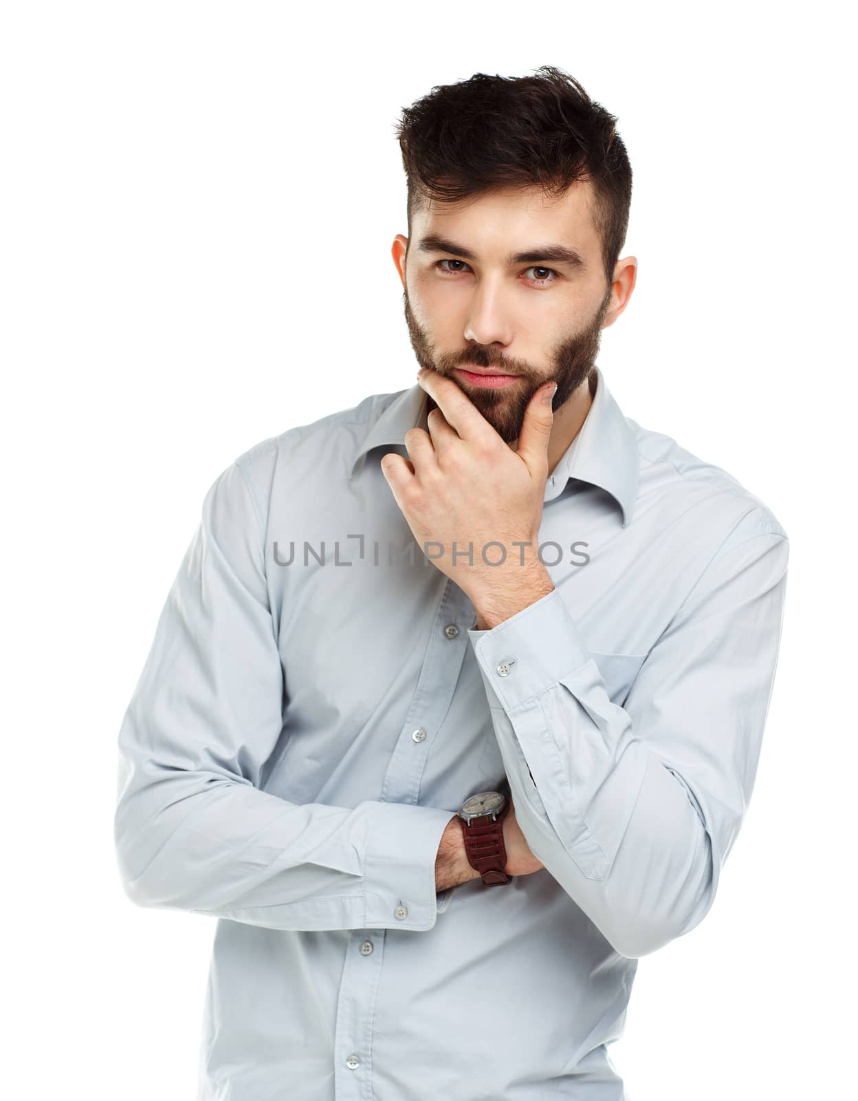 A young bearded man with a serious expression on his face isolated on white background