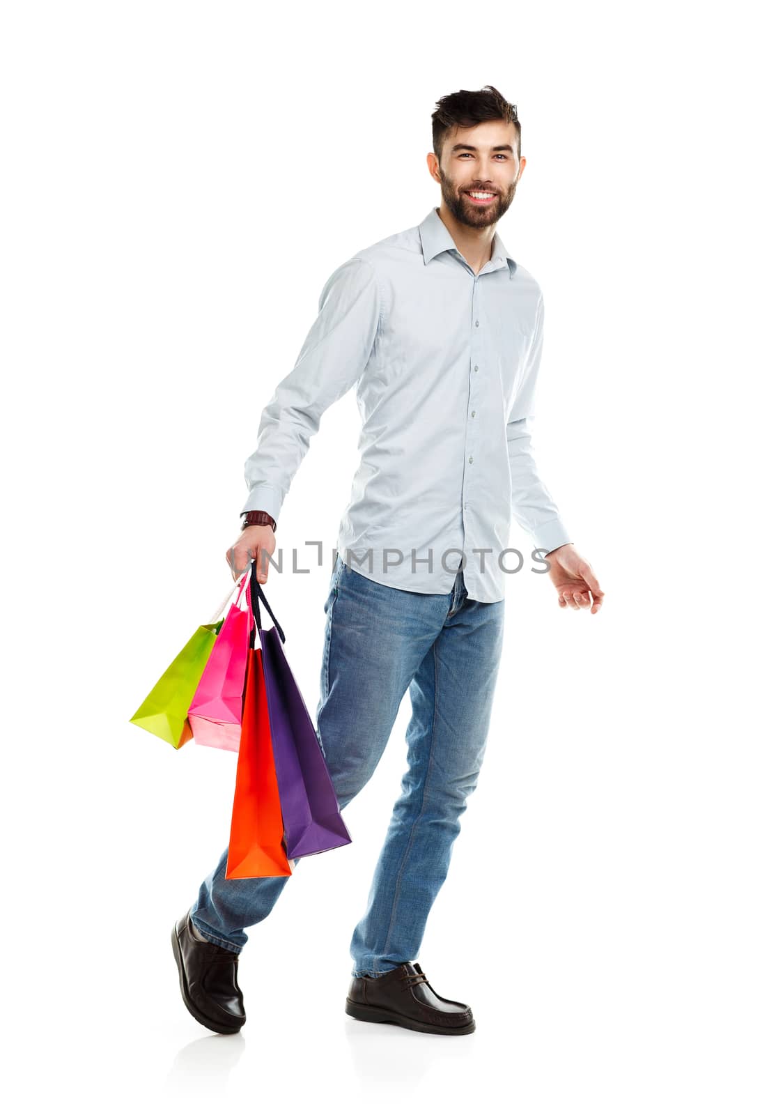 Handsome man holding shopping bags. Christmas and holidays concept