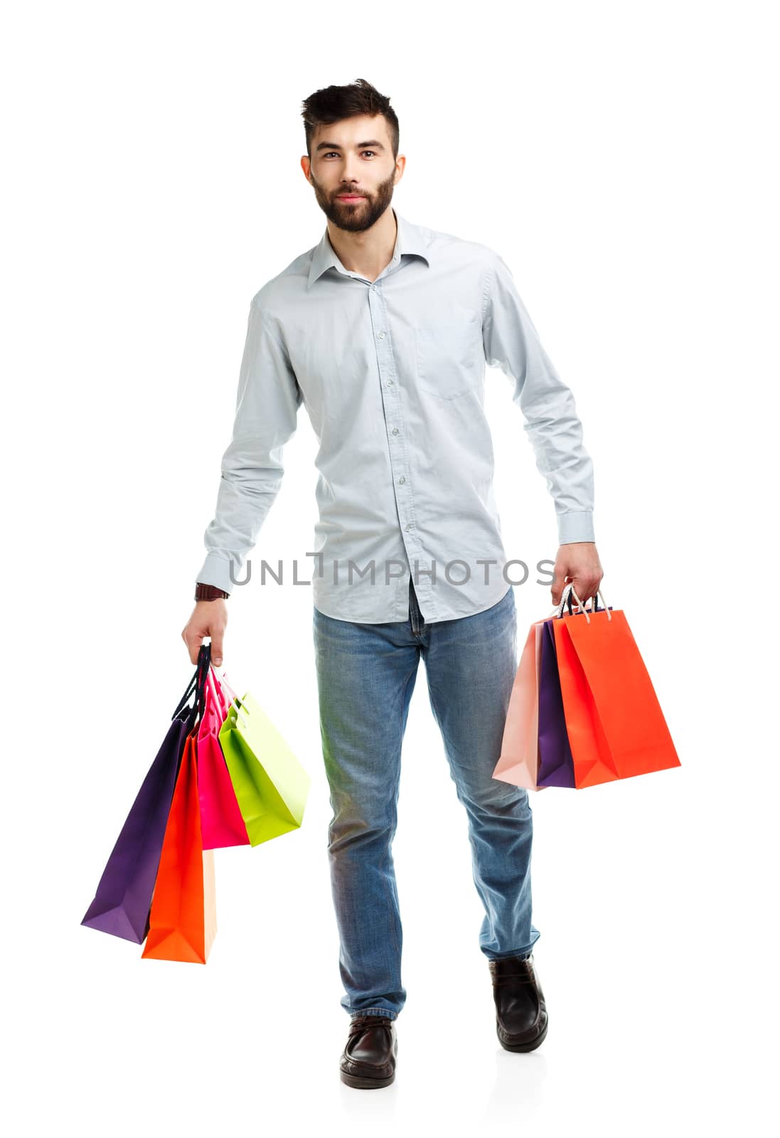 Handsome man holding shopping bags. Christmas and holidays concept
