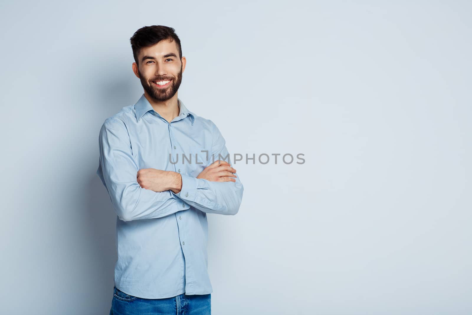 A young bearded man smiling