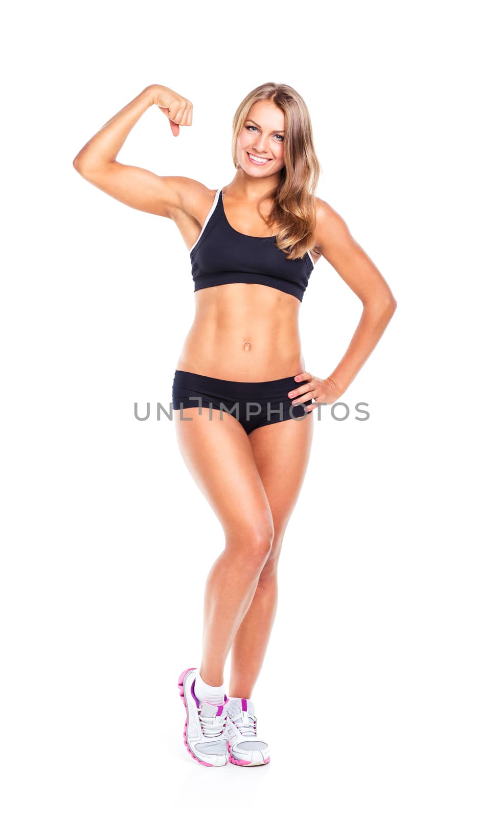 Young sports girl does exercises on a white background