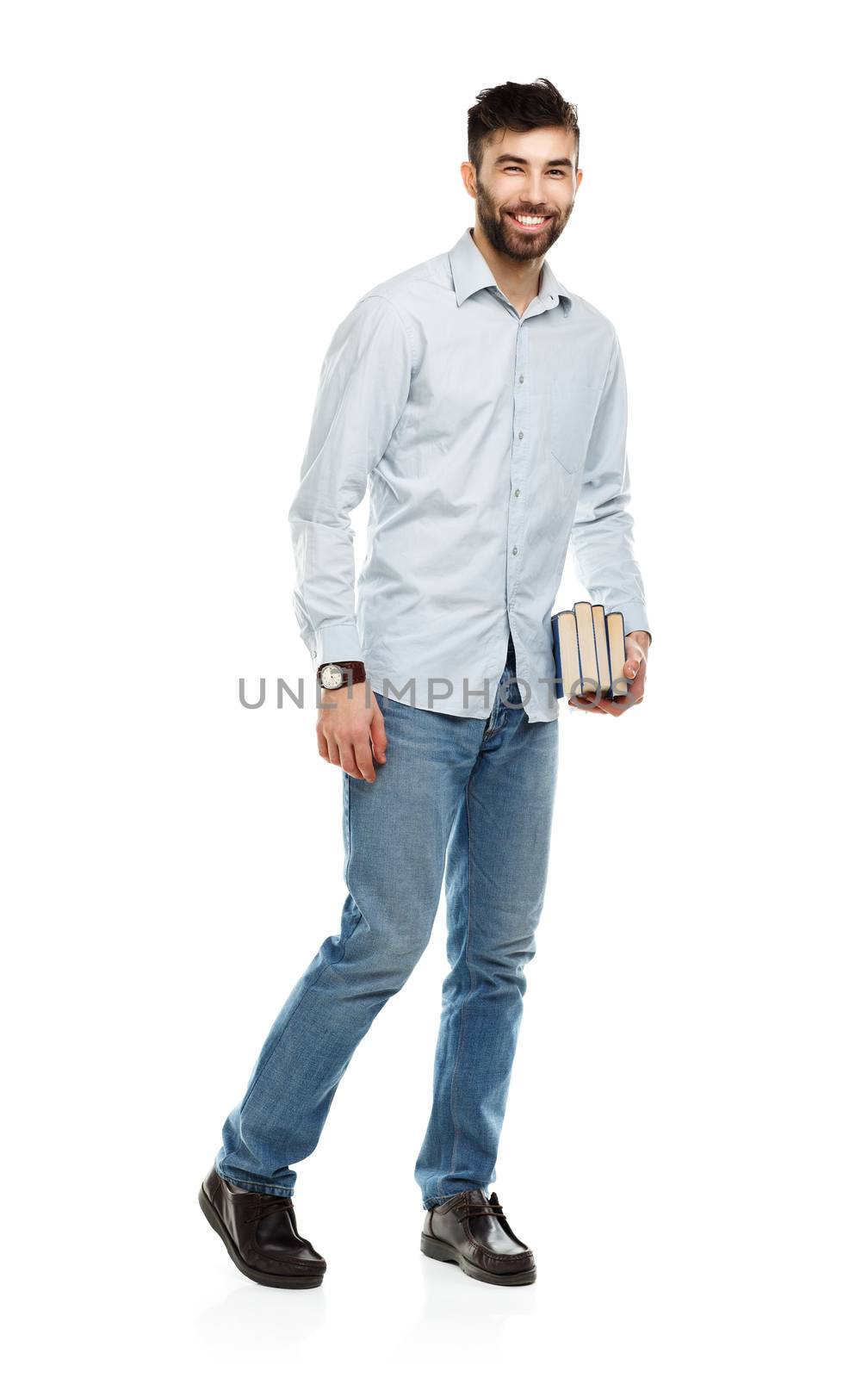 Young bearded smiling man with books in hands on white background