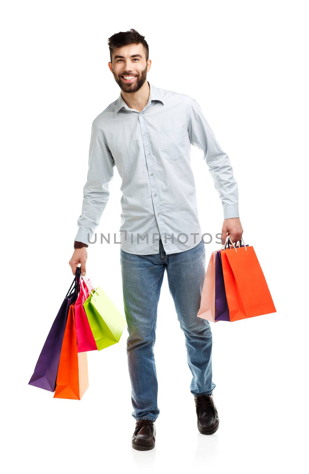 Handsome man holding shopping bags. Christmas and holidays concept